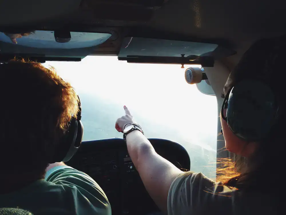 Instructor pointing to navigation display during flight briefing