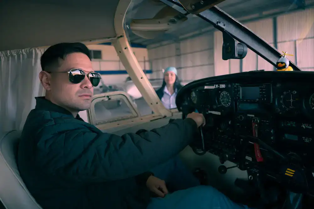 Professional flight instructor guiding a guest pilot inside the simulator